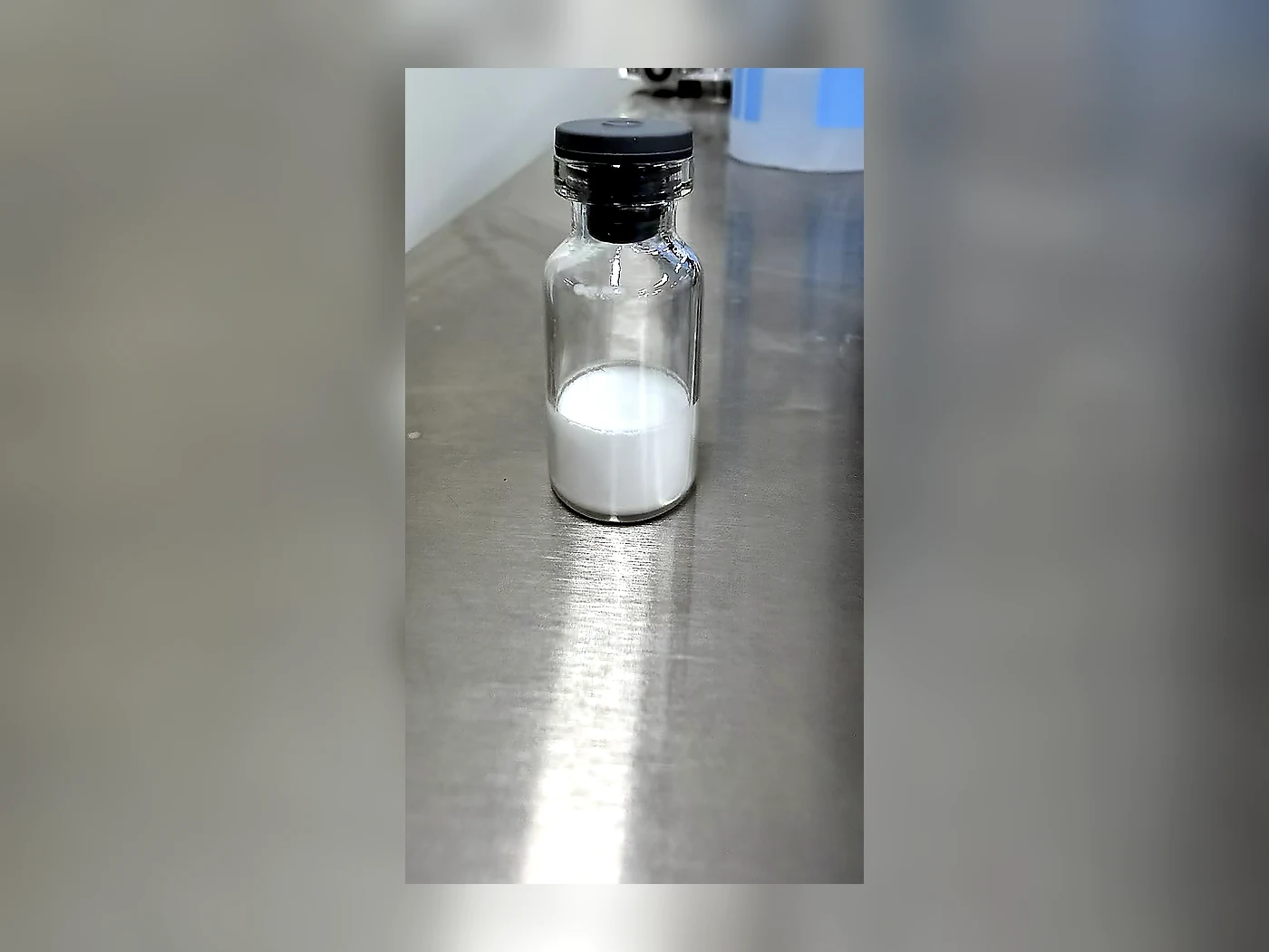 Single LyoPure Bio sample vial on a stainless steel laboratory surface